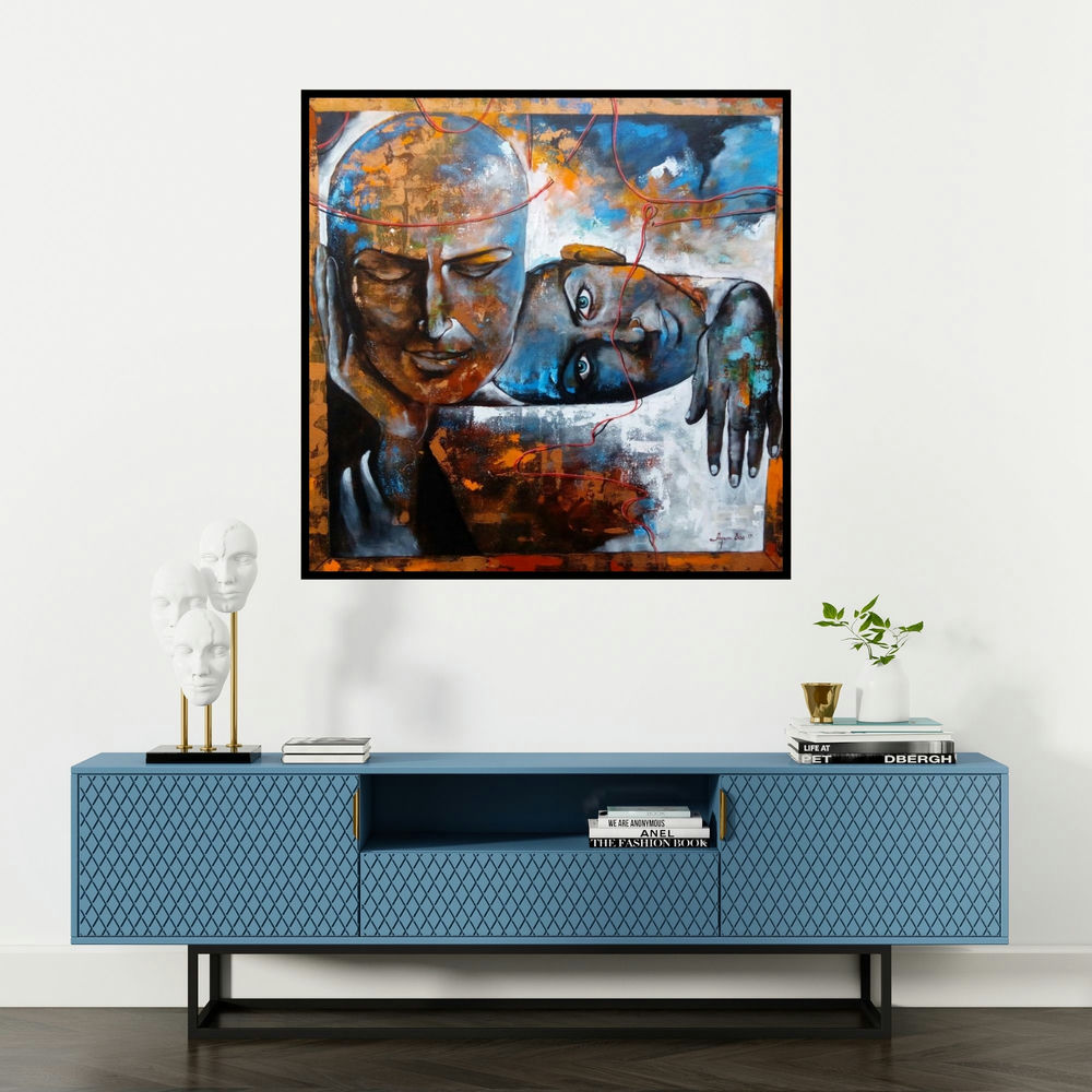 'The Caring Couple' painting by Arjun Das shown on a wall in a furnished room.