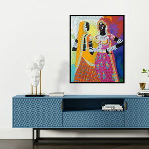 'Ethnic Serendipity 170 (Two Women in Traditional Attire)' painting by Anuradha Thakur shown on a wall in a furnished room.