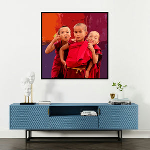 'Gnosis 14 (Three Playful Monk Kids)' painting by Umakant Tawde shown on a wall in a furnished room.