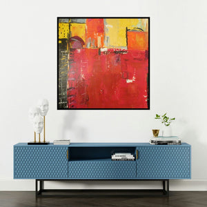 'painted puzzle (Interlocking Hues)' painting by Romaine Kaufman shown on a wall in a furnished room.