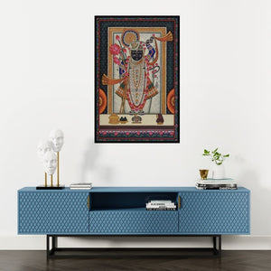 Preview of 'Pichwai (Shrinathji's Divine Splendor)' Painting by Unknown shown on a wall in a furnished room.