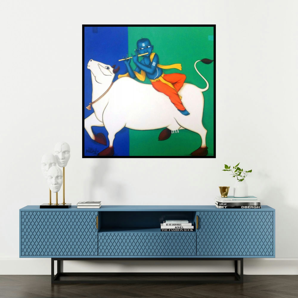 'Playing Flute With Cow (Divine Melody)' painting by Nitin Ghangrekar shown on a wall in a furnished room.