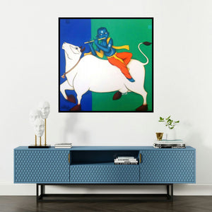 'Playing Flute With Cow (Divine Melody)' painting by Nitin Ghangrekar shown on a wall in a furnished room.