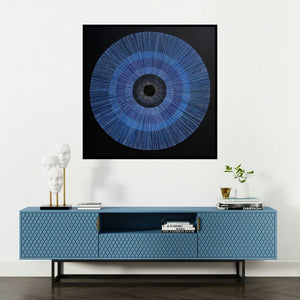 'The Source Of The Creation Of The (The All-Seeing Eye)' painting by Rajib Deyashi shown on a wall in a furnished room.