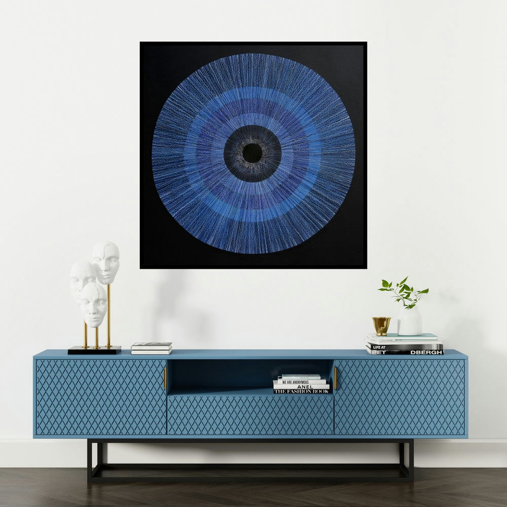 'The Source Of The Creation Of The (The All-Seeing Eye)' painting by Rajib Deyashi shown on a wall in a furnished room.