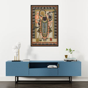Preview of 'Lord Sreenath Ji Pichwai Art' Painting by Artisan shown on a wall in a furnished room.
