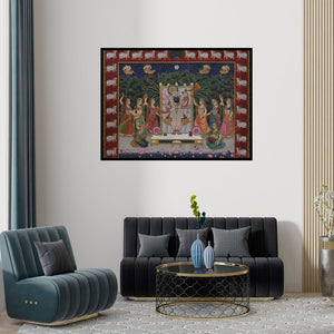 Preview of 'Pichwai (Shrinathji's Divine Court)' Painting by Unknown shown on a wall in a furnished room.