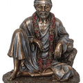 Religious handicraft titled 'Sitting Sai Baba', 6x6x6 inches, by artist Brass Handicrafts on Polyresin, Bronze