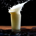 Food photography titled 'Squirt white cow&#039;s milk', 11x17 inches, by artist Rahmat Nugroho on