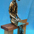 Figurative sculpture titled 'The Laptop Boy', 13x9x5 inches, by artist Usha Ramachandran on Bronze