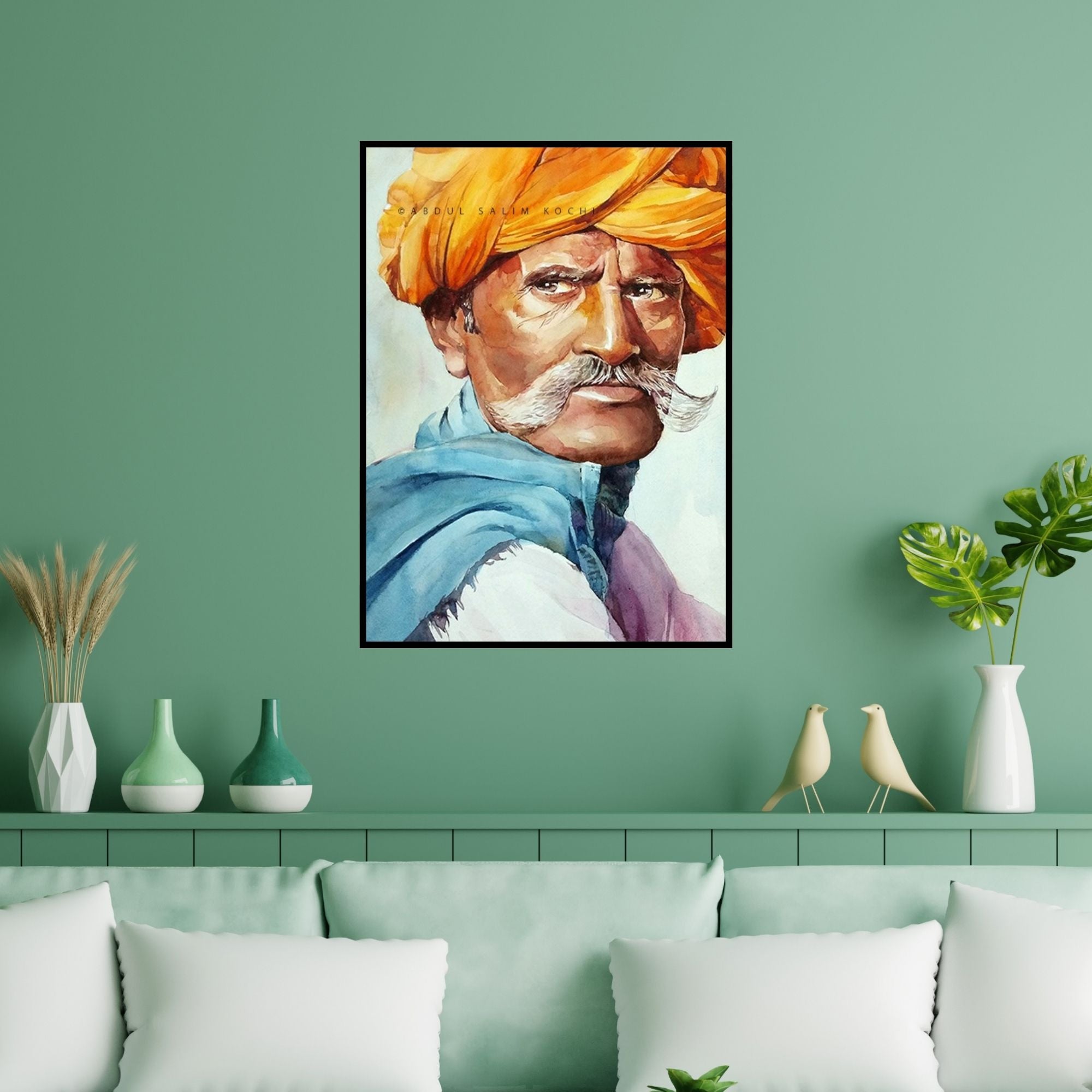 Preview of 'Turban Man 2' Painting by Abdul Salim shown on a wall in a furnished room.