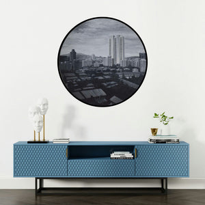 'Untitled 4 (Cityscape in a Circle)' painting by Ritesh Chopda shown on a wall in a furnished room.
