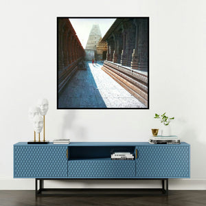 'Virupaksha Temple Hampi 1 (Temple Passage to Gopuram)' painting by Pravin Pasare shown on a wall in a furnished room.